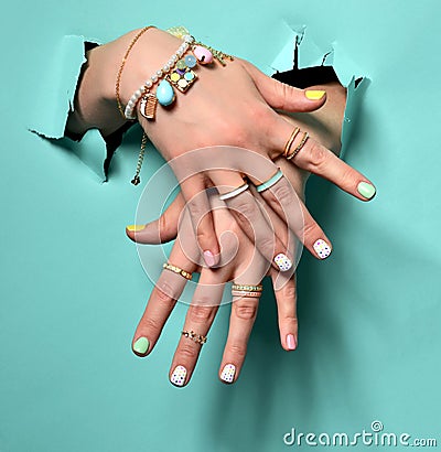 Beautiful woman hands with yellow pink white pattern nail polish Stock Photo