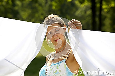 Beautiful woman hanging clothes Stock Photo