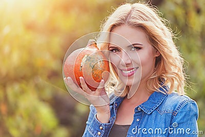 Beautiful woman harvesting pumpkins Stock Photo