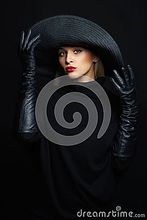 Beautiful woman in hat and leather gloves.halloween witch Stock Photo