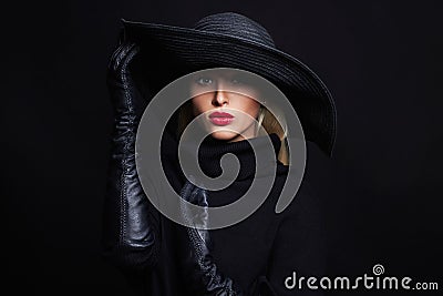 Beautiful woman in hat and leather gloves.halloween witch Stock Photo