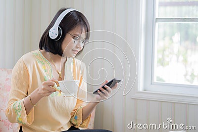 Beautiful woman with headphones and smartphone relaxing on Stock Photo