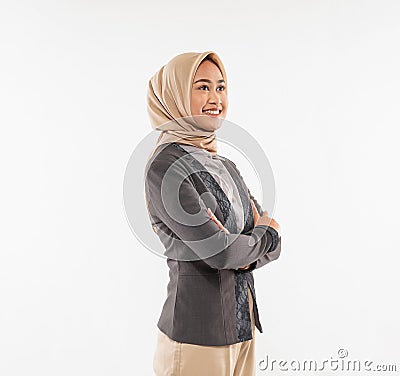 a beautiful woman with hijab standing looking up with hand crossed Stock Photo