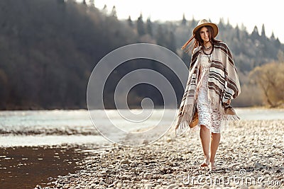 beautiful woman hipster walking on river beach in mountains, having fun and enjoying, boho travel concept, space for text Stock Photo