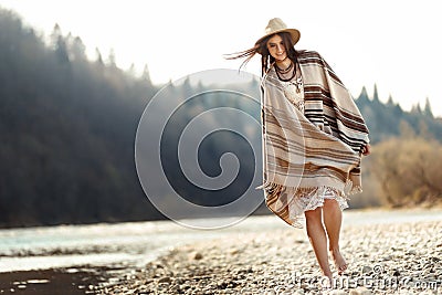 beautiful woman hipster walking on river beach in mountains, having fun and enjoying, boho travel concept, space for text Stock Photo