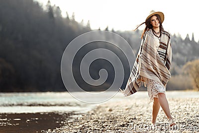 beautiful woman hipster walking on river beach in mountains, having fun and enjoying, boho travel concept, space for text Stock Photo