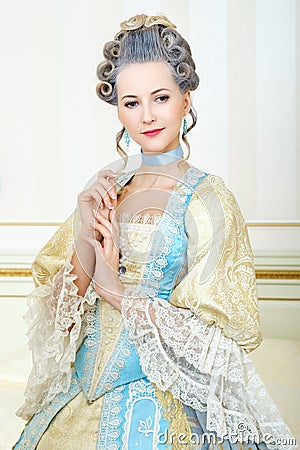 Beautiful woman in historical dress in Baroque style in the inte Stock Photo