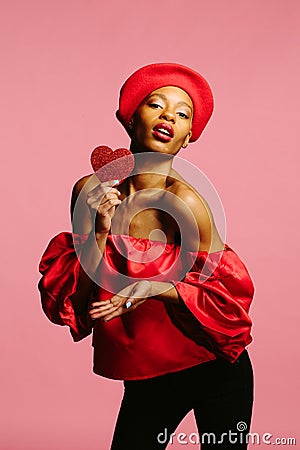 Beautiful woman holding red heart sending kiss Stock Photo