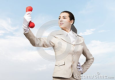 Beautiful woman holds handset phone on distance Stock Photo