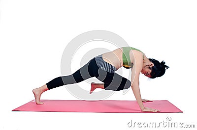 Beautiful woman indoor exercising using pink yoga mat Stock Photo