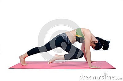 Beautiful woman indoor exercising using pink yoga mat Stock Photo