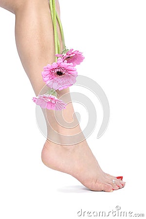Beautiful woman legs and feet with flowers Stock Photo