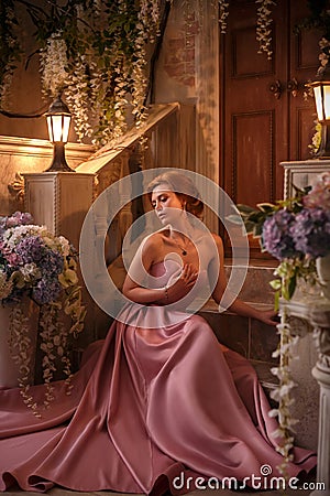 Beautiful woman in a luxurious pink dress Stock Photo