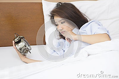 Beautiful woman lying on bed sleepless at night. Stock Photo