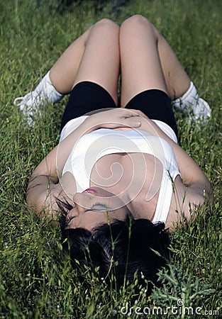 Beautiful woman lying on grass Stock Photo