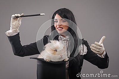 Beautiful woman magician with rabbit in hat Stock Photo