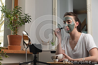 Beautiful woman making online course for facial beauty treatment at home Stock Photo