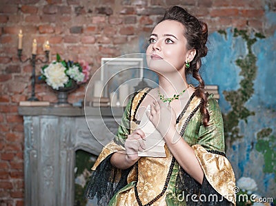 Beautiful woman in medieval dress received letter Stock Photo