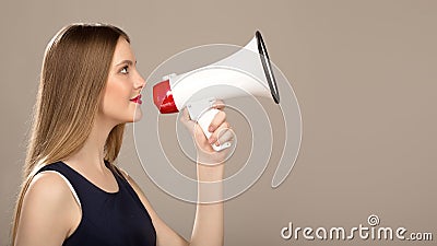 Beautiful woman with a megaphone in hand. Copycpase Stock Photo