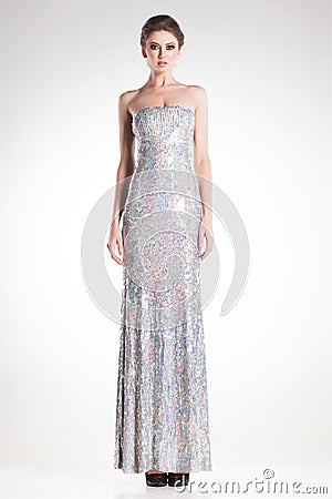 Beautiful woman model posing in long elegant silver sequins dress Stock Photo