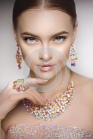 Beautiful woman in a necklace, earrings and ring. Model in jewel Stock Photo