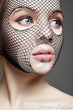 Beautiful Woman in Net on her Face. Girl in mask Stock Photo