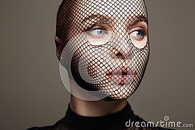 Beautiful Woman in Net on her Face. Pretty Girl in mask Stock Photo