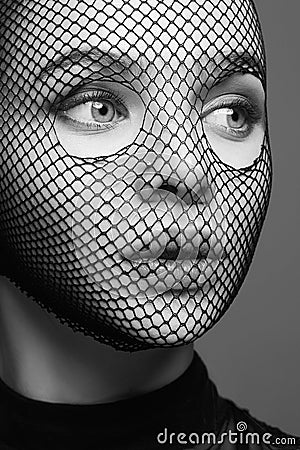 Beautiful Woman in Net on her Face. Pretty Girl in mask Stock Photo