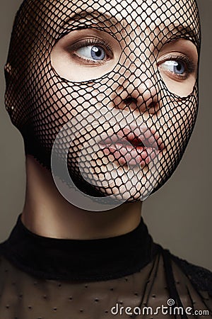 Beautiful Woman in Net on her Face. Sexy Girl in mask Stock Photo