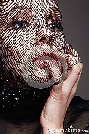 Beautiful Woman in Net on her Face. Sexy Girl in mask Stock Photo