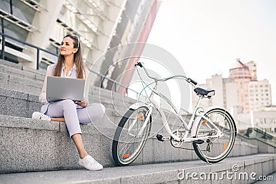 Beautiful woman office worker at lunch break working on laptop. Stock Photo