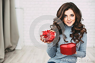 Beautiful woman open a gift shape heart. Stock Photo