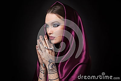 Beautiful woman in oriental style with mehendi Stock Photo