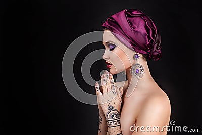 Beautiful woman in oriental style with mehendi Stock Photo