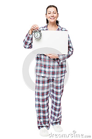 Beautiful woman in pajamas with a poster and an alarm clock Stock Photo