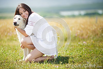 Beautiful woman plays with the dog on the Meadow Stock Photo