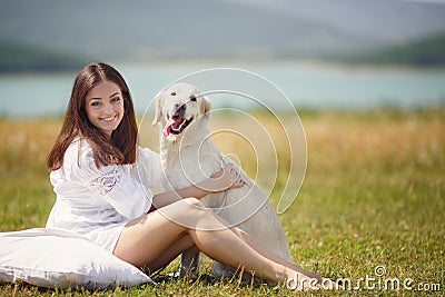 Beautiful woman plays with the dog on the Meadow Stock Photo