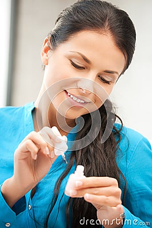 Beautiful woman polishing her nails Stock Photo