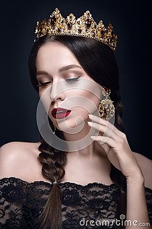 Beautiful woman portrait with crown and earrings. Stock Photo