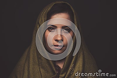 Beautiful woman portrait with green scarf over her head, studio shot Stock Photo