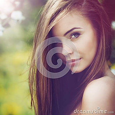 Beautiful woman portrait. Young cheerful girl with long brown ha Stock Photo