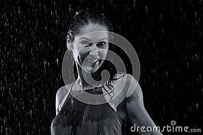Beautiful woman in rain at night getting wet artistic conversion Stock Photo