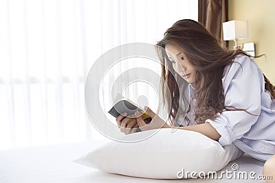 Beautiful woman reading a diary in the bedroom Stock Photo