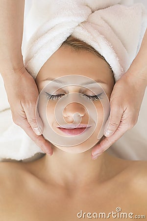 Beautiful Woman Receiving Facial Massage In Spa Stock Photo