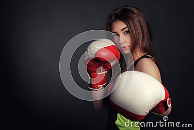 Beautiful woman with the red boxing gloves,black background Stock Photo