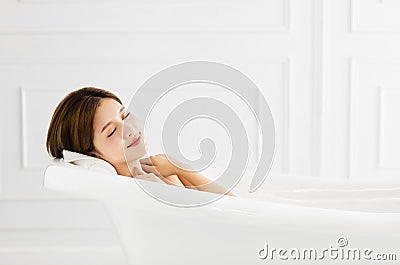 Beautiful woman relaxing in bathtub Stock Photo