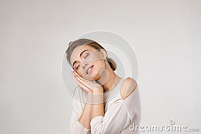 Beautiful woman is showing sleep gesture Stock Photo