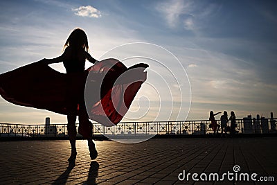 Beautiful woman silhouette with a wide hem of Stock Photo