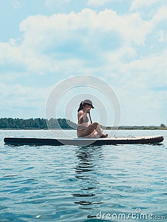 beautiful woman sitting down on the supboard Stock Photo