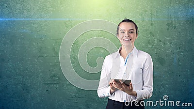 Beautiful woman in skirt with ban looking into a touch pad, isolated studio background with copyspace. Business concept. Stock Photo